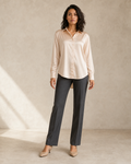 Modelo con blusa de manga larga color champán, vista frontal tres cuartos